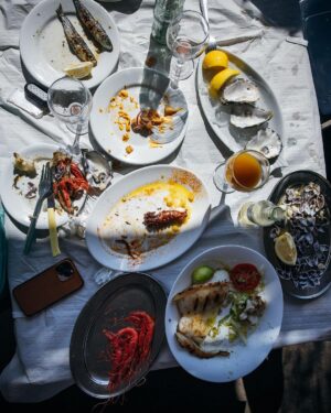 Adam Liaw Instagram - Spanish yum cha? Visiting my brother who lives in a village just outside Malaga. Seaside restaurants right on the beach serving seafood grilled over hot coals. Waiter walk around with the plates and you just grab what passes you by. The bill is tallied up at the end and written straight on the paper lining the table. With a few glasses of tinto de verano it’s the best way to spend a warm afternoon.