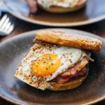 Adam Liaw Instagram - Our final episode of #AdamandPoh’s Great Australian Bites starts very soon on @sbsfood and we’re exploring @visitcanberra’s amazing food scene and FINALLY answering the question of what is Australia’s national dish? We eat what might be Australia’s best banh mi, make a pretty incredible bacon and egg roll, and put on the best sausage sizzle the country has ever seen, before having the results of our national dish poll read by a very special guest! …. … 🚨 It’s the Prime Minister. The special guest is the Prime Minister. 🚨 #visitcanberra