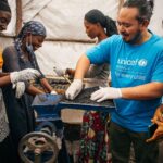 Adam Liaw Instagram - This is the UNICEF-supported #GreenGirls initiative where young women from #Sobel produce ecological charcoal from collected waste. We often think of the effects of climate change first impacting low-lying island nations, but #Sobel is a camp for more than 6000 Burundians who have been displaced because of extreme flooding caused by climate change. Climate change is already having a big impact on Burundi, from increasing frequency of extreme weather events like flooding, to decreased agricultural yields caused by prolonged rainy seasons. The Green Girls program an ingenious multi-dimensional solution to may of the problems facing these climate refugees. Firewood collection is a task usually performed by young women, who may have to walk for hours to find appropriate firewood. This exposes them to a high risk of sexual assault, and firewood collection contributes to deforestation. By producing ecological charcoal the girls don’t have to search for firewood, protecting them from potential assaults, and it also reduces deforestation and provides them with an additional source of income from the sale of surplus charcoal. An ingenious solution to a multi-dimensional problem. It was fabulous to see this initiative first-hand, chat with the girls and play with many of the kids from Sobel.