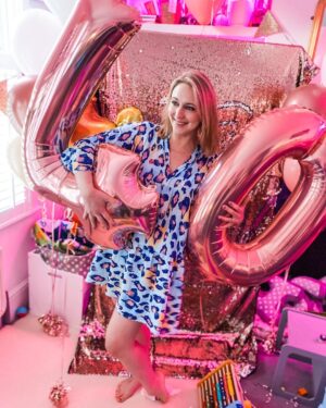 Ali Bastian Instagram - So this is 40! Thank you so, so much for all of your amazing messages. I had a lovely weekend filled with friends and family time and feel very grateful, especially in light of how alarming and turbulent everything is right now. Certainly makes me want to hold my fam a little closer.
In terms of turning 40… it actually feels ok! … certainly a lot better than turning 30 felt! I remember really struggling with 30 - I was on the road touring with a musical, very lonely and homesick and actually spent the day in my digs in bed with bronchitis!  I remember feeling that I wasn’t at the stage I ‘should’ be, as if there where these invisible boxes I ‘should’ be ticking… crazy really… Where my 20s were non-stop career wise, my 30s seemed to be about career and relationship highs and lows and getting well and truly lost in order to begin to ‘find myself’ … only to realise that I was never really lost to begin with, I was always there… just so busy I had forgotten how to feel. How to trust my instincts, how to listen to my knowing, how to sit with myself no matter how uncomfortable and uneasy and to comfort the parts of me that needed tending to… instead of running from them. In truth, I’m still working on ALL of this… I’m putting one foot in front of the other… but if 40 has invited in anything for me, it’s the deep desire to truly show up for myself and in turn, show up fully for those around me. 💜💫 *edited* It has just been brought to my attention that I have a baby wipe stuck to my foot in this photo 🤣… and that’s ok with me too. I’m here for all of it 😂💜