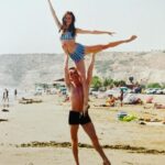 Amy Bailey Instagram - Beach day throw back... (or in @miniateam ‘s case, throw your wife around 🏋🏼‍♀️🤸‍♀️) ...to simpler days 🌞