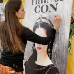 Amy Bailey Instagram - I was recently informed by a lovely fan that my enormous face from a poster signing at @germancomiccon now lives in their wine cellar. I promise you, @nido1443 , that smug expression is one of camaraderie. She won’t judge. She may have killed others with a glass of wine or two, but you’re safe…as long as you remain a loyal subject, that is. ⚔️👸🏻💀 #DontDrinkTheWine