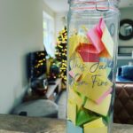 Andrea McLean Instagram - This jar is one of our most treasured possessions, and the fact that it is full feels miraculous. My sister started us on the tradition of writing down on coloured paper every little win we have as a family throughout the year. It doesn’t matter how small it may seem to anyone else, our motto is: “If it matters to you, it matters to us”, so we write it down and pop it in. A few years ago, my wonderful This Girl Is On Fire community joined together to present me with this jar, and they filled it with all the positive changes they had seen themselves since joining me. To be honest, I cried my eyes out when I got it because it meant so much, and seeing this jar sitting in my kitchen waiting to be filled at the start of each year, knowing they gave it to me and had such faith in me, is a huge motivator for keeping going when things are tough. This year has been one of our most challenging yet as a family; and it touched all of us, in every part our lives. We are not where we thought we would be. The big, bold audacious goals we made over a year ago are nowhere to be seen… And yet. We survived. I am healthy and well. Our family is well. We made new plans and discovered new paths, and we are walking along those ones now. We love each other and are loved in return. Our jar of little wins will be emptied today, and we will read them and remind ourselves of everything good that happened and the progress we made. I will collect them all and keep them in an envelope marked “2023 Jar” and put them with the others. And tomorrow we start again. Happy New Year to you, and may your 2024 jar be full. #newyear