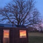 Anna Passey Instagram - The last few days have really felt like Spring is just around the corner, what better way to watch the changing of the seasons than totally immersed in nature. We have had the most UNREAL stay with @unyoked.co who have long had their cabins in AUS and NZ but now LUCKILY have some of their gorgeous little hideaways in UK. Perfect little retreats in the middle of nowhere, ideal for unwinding, relaxing and resetting to nature’s pace. Morning frost, epic sunsets, outdoor cooking and a warm snuggly bed, what more could you need?? Thank you for having us Unyoked 🤍 #kindlygifted The Middle of Nowhere