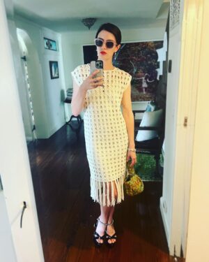 Anna Wood Instagram - Well I was originally going to a certain premiere of a certain movie with a certain man I love in it. But I ain’t no scab, hunty. #SagStrike #UnionStrong #payyourartists 

I can’t help but feel honored and thankful to the amazing upstate designers I was lucky to collab with on this insanely cool lewk. To @eleven.six for this modern, timeless, comfy, elevated, effortless dream dress: THANK YOU! To @madebymle for this functional art that both glams me up tenfold, makes the room sparkle, and hides my snacks: THANK YOU! And of course to @waginnboarding for always welcoming my poodle with open arms: THANK YOU! 
Hair/make up: me 😎
Glasses: @dleyewear 
Shoes/bracelet/earrings: @prada 
Photography/resident hottie: @danedehaan