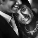 Arjun Kamath Instagram - Vasudaa and Harsan's wedding reception was a jolly affair, each passing minute marked by exuberance, colours, and laughter. As the busy day approached an end, we decided to make a few heartfelt portraits of the couple, away from the buzz of the celebrations. Slightly mellowed down by the chain of festivities, the newlyweds got the chance to catch a quiet breath in each other's company only when I began taking their candid photographs. That's when Vasudaa leaned in & rested her head on Harsan’s shoulder, as if stepping into a warm bubble of contentment. Watching this precious moment unfurl, I instantly brought in a light and made this beautiful portrait, as a warm smile lingered on our faces. In her eyes, I could see comfort and this rare feeling called "forever", and I'm glad I was able to freeze it into permanence. @harsan_raghu @vasudaa1611 Lit with a @profoto B10 @canonindia_official @srishtidigilife #weddingphotography #photography #bride #groom #wedding #indianwedding #arjunkamathphotography #blackandwhite #instagram #DoGreatWithCanon #MentorsInFocus #EOSMaestro Karur Town