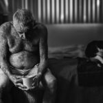 Arjun Kamath Instagram - Super glad that my entry ‘Holding On...’ was awarded an Honourable Mention (Portrait, Professional) at the Monochrome Awards 2020. The story behind the image: I made this image of Robert Weiner, a Los Angeles based actor, in his studio apartment in Chula Vista, LA. Often the images that appeal to me the most as a storyteller originate from the simpler, everyday moments of life. Robert sits on the bed, lost in his thoughts, accompanied by his cup of coffee and pet cat on an overcast LA morning. Shot in the city where golden dreams brew, the picture brushes the thought that LA is vibrant, but at the same time, it can also make one feel left out in an instant with its fast-paced life. Resonating with this idea, I envisioned the photograph in black and white, as the frame confirms a personal belief. That in the end, we are all alone in fighting our own battles, one day at a time. This photograph is hence all barebones, visually conveying the philosophy of life through powerful emotions and a simple story, both enhanced by the deprivation of colours. In the viewer, it also enlivens the familiar reality of old age and the challenges it brings. And while old does not mean different, things slow down for sure. Thus, in the picture, the cat leaving the frame contrasts with the evident stillness of the old gentleman. It also metaphorically conveys that he will soon be alone, adding another flavourful layer to the image. #CapturedOnCanon with a Canon EOS 5D Mark III #arjunkamathphotography #award #honourablemention #blackandwhite #monochromeawards #instagram #DoGreatWithCanon #MentorsInFocus #EOSMaestro Los Angeles, California