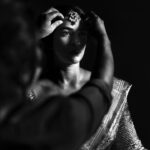 Arjun Kamath Instagram - It was dusk and the moon was just gathering its glimmer as it rose outside the window. The stars had taken over the sky, and were now twinkling to the mellow music that played in the room. Amidst this tranquil setting, there sat @anishadeevakonda , gracefully humming to the melodies as she prepared for the wedding ceremony. It was hard not to notice the sheer radiance that she was doused in, overshadowing all other plain movements around her. It was indeed a delight to click the otherwise jovial bride in such serene moments of stillness, suave, and contemplation. #CapturedOnCanon with a Canon EOS 5D Mark IV + Canon EF 50mm f 1.2/L Lit with a couple of @profotoglobal B10’s at varying intensities #bride #makeup #gettingready #wedding #wedmegood #weddingphotography #blackandwhite #hyderabad #arjunkamathphotography #CapturedOnCanon #DoGreatWithCanon #MentorsInFocus #srishtidigilife Hyderabad