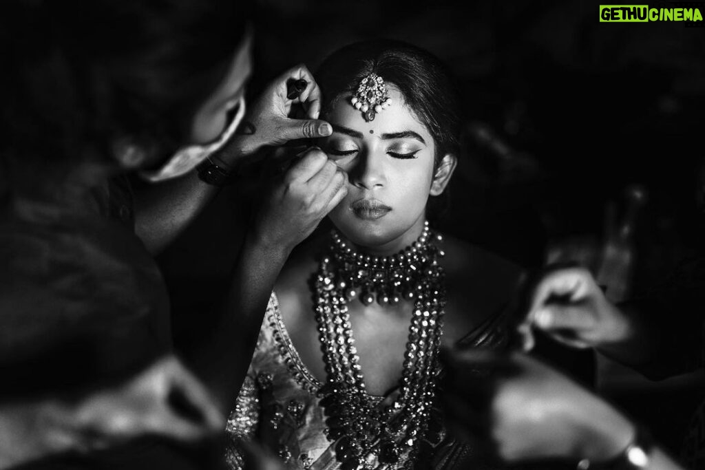 Arjun Kamath Instagram - It was dusk and the moon was just gathering its glimmer as it rose outside the window. The stars had taken over the sky, and were now twinkling to the mellow music that played in the room. Amidst this tranquil setting, there sat @anishadeevakonda , gracefully humming to the melodies as she prepared for the wedding ceremony. It was hard not to notice the sheer radiance that she was doused in, overshadowing all other plain movements around her. It was indeed a delight to click the otherwise jovial bride in such serene moments of stillness, suave, and contemplation. #CapturedOnCanon with a Canon EOS 5D Mark IV + Canon EF 50mm f 1.2/L Lit with a couple of @profotoglobal B10’s at varying intensities #bride #makeup #gettingready #wedding #wedmegood #weddingphotography #blackandwhite #hyderabad #arjunkamathphotography #CapturedOnCanon #DoGreatWithCanon #MentorsInFocus #srishtidigilife Hyderabad