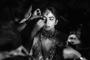 Arjun Kamath Instagram - It was dusk and the moon was just gathering its glimmer as it rose outside the window. The stars had taken over the sky, and were now twinkling to the mellow music that played in the room. Amidst this tranquil setting, there sat @anishadeevakonda , gracefully humming to the melodies as she prepared for the wedding ceremony. It was hard not to notice the sheer radiance that she was doused in, overshadowing all other plain movements around her. It was indeed a delight to click the otherwise jovial bride in such serene moments of stillness, suave, and contemplation.

#CapturedOnCanon with a Canon EOS 5D Mark IV + Canon EF 50mm f 1.2/L 

Lit with a couple of @profotoglobal B10’s at varying intensities 

#bride #makeup #gettingready #wedding #wedmegood #weddingphotography #blackandwhite #hyderabad #arjunkamathphotography 
#CapturedOnCanon #DoGreatWithCanon  #MentorsInFocus #srishtidigilife