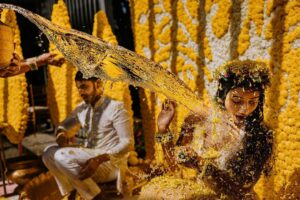 Arjun Kamath Instagram - The Haldi festivities of Sreethika and Ranadeep kicked off at The Wildflower in Medchal, with the sun shining bright and the beautiful yellow decorations popping against the greenery. It was a lovely sight to see! 

The happy couple fully embraced the Haldi festivities, with their family members applying Haldi to their faces one by one. Laughter filled the air, occasionally accompanied by a refreshing spray of cool water, as the sun rose in a golden hue.

Watching the beautiful ceremony, I couldn't help but smile at the bright colours and joyful laughter. However, my attention was diverted when Sreethika's friend suddenly appeared and playfully splashed water onto her face like a mischievous wizard! Sreethika was utterly shocked and surprised by the sudden splash of saffron water. As her giggly friend rushed over with the water pot, startling Sreethika into a scream, I remained focused on the moment. Reacting quickly, I captured the delightful moment in seconds, preserving it for eternity.

I must confess that I appreciate candid pictures as they capture genuine moments that posed shots often lack. The essential element of a photo is to convey the emotions of the moment rather than just aiming for a flawless pose. Even if they're not perfect, candid photos can evoke cherished memories that we hold dear. Ultimately, a picture without emotion is like a rainbow with only one colour.

Sreethika & Ranadeep, Hyderabad- Dec ‘22

@canonindia_official 
@srishtidigilife 

#bride #haldi #haldiceremony #yellow #sunrise #water #splash #emotions #wedding #weddingphotography #weddingdecoration #telugubride #DoGreatWithCanon #MentorsInFocus #EOSMaestro #instagram #arjunkamathphotography