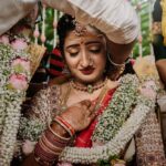 Arjun Kamath Instagram - To be a bride is to gracefully pirouette through a vibrant medley of emotions. It is to live all the love, happiness, and anticipation that life can muster in a single day and in the presence of everyone you love and cherish. At Nishitha and Sushanth's wedding, I enjoyed capturing a holy union through two culturally unique but equally breathtaking wedding ceremonies. Dawn arrived with golden sunshine, the enchanting melody of shehnais, and the air was blanketed in the sweet scent of jasmine and pink roses. The wedding dais was bursting with emotions galore, forming a precious sight brought forth by a love marriage. As Sushanth tied the tali to honour the sacred bond, I saw Nishitha drop a pearly tear in silence. This delicate moment brought forth the sheer love and longing the bride must have carried in her heart for all this time. As if the joys, anticipations, and bittersweet goodbyes brought forth by marriage found their way onto Nishitha's glistening cheeks, telling a powerful story through their fleeting journey. By afternoon, the families had dressed up again to celebrate the big day in Malayali style. Nishitha wore a gorgeous white saree with delicate golden jewellery, while Sushanth complimented the mellow tones in a silken red shirt and white lungi. As the bright sun journeyed in the sky, for a brief moment, the two cultural ceremonies effortlessly entwined. It was time for Sushanth to tie the tali on Nishitha's neck again. Only this time, we saw the elated bride engrossed in the joyous moment, celebrating all the happiness the ceremonies brought about through a cheery smile. And thus, for the storyteller in me, these two contrasting images celebrate Nishitha's rich and emotional journey on her big day. From laughter as bright as the sun and tears as precious as the moonshine, she lived the momentous wedding day to its full potential, and today, with these photographs, I wish to celebrate just that. Nishitha & Sushanth, Bengaluru - Nov ‘22 @canonindia_official #bride #tears #emotions #wedding #weddingday #groom #weddingphotography #weddingday #DoGreatWithCanon #MentorsInFocus #EOSMaestro #instagram #arjunkamathphotography Royalton Leisure