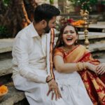 Arjun Kamath Instagram - Unbound laughter, graceful moments of love, and the sublime beauty of nature. I had the perfect elixir to craft the prewedding portraits of Sharadh and Sharayu, two jovial folks who could light up any room they walked into. The gentle morning sun was by our side as we strolled the verdant milieus of Tamarind Tree, Bengaluru. Whiffs of crisp air enchanted us, fragrant with the scent of fresh flowers and mud. Accompanying us were tiny colourful birds and the golden rays of the sun, as we explored the little green pockets of serenity around us. That morning, Sharadh and Sharayu had arrived in an adorable lighthearted spirit. Their traditional attires of red and white complemented the earthy tones of Tamarind Tree, and their radiant smiles did the rest of the trick. We spent the next few hours immersed in sweet laughter and love, as I pictured them in all their beauty and grace. I still remember the precious look in their eyes and the warmth they shared with each other. Perhaps that gives these photographs the special place they have in my heart. That I collected all the love, light, and laughter from those moments and gave them to the couple to cherish forever. #CapturedOnCanon with a @canonindia_official EOS R5 with a CanonRF 24-70 f/2.8 L USM #preweddingshoot #indian #couple #love #laughter #preweddingphotography #prewedding #indianwear #indianphotography #indianfashion #saree #sareelove #flowers #sunrise #arjunkamathphotography #bangalore #DoGreatWithCanon #MentorsInFocus #EOSMaestro #instagood #instagram The Tamarind Tree