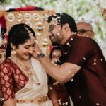 Arjun Kamath Instagram - To be a bride is to gracefully pirouette through a vibrant medley of emotions. It is to live all the love, happiness, and anticipation that life can muster in a single day and in the presence of everyone you love and cherish. At Nishitha and Sushanth's wedding, I enjoyed capturing a holy union through two culturally unique but equally breathtaking wedding ceremonies. Dawn arrived with golden sunshine, the enchanting melody of shehnais, and the air was blanketed in the sweet scent of jasmine and pink roses. The wedding dais was bursting with emotions galore, forming a precious sight brought forth by a love marriage. As Sushanth tied the tali to honour the sacred bond, I saw Nishitha drop a pearly tear in silence. This delicate moment brought forth the sheer love and longing the bride must have carried in her heart for all this time. As if the joys, anticipations, and bittersweet goodbyes brought forth by marriage found their way onto Nishitha's glistening cheeks, telling a powerful story through their fleeting journey. By afternoon, the families had dressed up again to celebrate the big day in Malayali style. Nishitha wore a gorgeous white saree with delicate golden jewellery, while Sushanth complimented the mellow tones in a silken red shirt and white lungi. As the bright sun journeyed in the sky, for a brief moment, the two cultural ceremonies effortlessly entwined. It was time for Sushanth to tie the tali on Nishitha's neck again. Only this time, we saw the elated bride engrossed in the joyous moment, celebrating all the happiness the ceremonies brought about through a cheery smile. And thus, for the storyteller in me, these two contrasting images celebrate Nishitha's rich and emotional journey on her big day. From laughter as bright as the sun and tears as precious as the moonshine, she lived the momentous wedding day to its full potential, and today, with these photographs, I wish to celebrate just that. Nishitha & Sushanth, Bengaluru - Nov ‘22 @canonindia_official #bride #tears #emotions #wedding #weddingday #groom #weddingphotography #weddingday #DoGreatWithCanon #MentorsInFocus #EOSMaestro #instagram #arjunkamathphotography Royalton Leisure