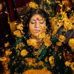 Arjun Kamath Instagram - Memories from a day when the sun came down to play with us. 💛 Nidhi's glorious wedding ceremony was preceded by the most jovial and colourful haldi celebration. The morning was still young and fresh at the Heritage Khirasara Palace of Rajkot. The family was painted in a bright and inciting yellow for the haldi, bringing the scene to life with a riot of colours and celebration. As I walked the vibrant space, I was glad to observe the mirth that filled the air along with all the sparkle and gold. The ladies sang folk songs and danced in circles, the kids played catch in all their liveliness, and Nidhi, laced in grace and charm, was taking in each precious moment as felicity unfurled around her. To my delight, these pictures reflect the pure joy that filled the room that morning. Each moment bursted with colour and energy, and I was grateful to revel in its glory as I froze those precious emotions in time. Today, when I see these photographs, I can't help but transport myself back to that sprightly morning and feel the bliss I felt then all over again. Nidhi+Shirish, February 2022 #CapturedOnCanon with a @canonindia_official EOS R5 with a CanonRF 24-70 f/2.8 L USM #weddinng #weddingphotography #weddingphotographer #weddingflowers #haldiceremony #haldi #indianwedding #arjunkamathphotography #rajkot #DoGreatWithCanon #MentorsInFocus #EOSMaestro #instagood #instagram