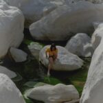 Ashima Shiraishi Instagram - The rocks, ever-evolving, are shaped into curved and glacial looking sculptures by the water. Lao Tzu once said, “Water is fluid, soft, and yielding. But water will wear away rock, which is rigid and cannot yield. As a rule, whatever is fluid, soft, and yielding will overcome whatever is rigid and hard. This is another paradox: what is soft is strong”. Water being soft and strong reminds me of the soft power of storytelling. Here’s one story: before Los Angeles was even a word on a map, it was called Tovaangar, the territory of the Tongva, Chumash and Kizh, who were then enslaved to build the San Gabriel Mission and San Fernando Mission. It may be unsettling to realize but urban areas that have become so ingrained in our collective consciousness as “American” were once native land, too. 📍Chumash, Kizh, Fernandeño Tataviam, Micqanaqa’n and Tongva land 📍Support and donate to @tongva.land (Tongva Taraxat Paxaavxa Conservancy) a Tongva led land conservancy in Tovaangar where land has returned to their hands for the first time. @noahsahady pic @arcteryx used gear fit
