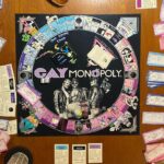 Augustus Prew Instagram - Playing Gay Monopoly on Fire Island with some of my chosen family is truly what life is all about and exactly what nature intended. Thank you Weather Queen for honoring our games night with a dramatic storm, it added the chicest snuggliest backdrop to our games night. Love ya girl. Quick bit of history- Gay Monopoly was an unofficial tongue in cheek version of monopoly developed by “The Parker Sisters”- truly some of the wittiest writers of all time (see “You were caught eating quiche”card) in 1983 to raise money to fund AIDS research which at the time was already devastating the gay community and which very little was being done to prevent by the (straight) powers that be (google Larry Kramer/Eric Sawyer/Anthony Fauci). You could buy it in stores and everything until Parker Brothers (owners of the actual monopoly game) sued them for copyright infringement because a)they are homophobic capitalists (ironic also given that the game was initially created to warn against capitalism) and b) they are boring (see Straight City photo to understand that reference). It’s now a really rare gem of a game so if you have/find one, look after it with all your heart and keep it close because it has immense historic significance. My favorite part of the game is the “Do you know your queer history?” card, where if you land on it have to answer a question about influential queer people throughout history- I learned about George Washington Carver, HansChristian Andersen and Benjamin Britten and was reminded of the passage in the Bible that tells us that King David loved his boyfriend Jonathan “surpassing the love of a woman” in the book of Samuel. Yes that’s actually in the Bible so you can keep that one for your next holiday season. Oh and the Benjamin Britten was gay. Didn’t know that either. Playing it amongst the ghosts of Fire Island (many many many queer people died of AIDS here- most had nowhere else to go) and a mere block from the house of Patient Zero (the first known person to be infected by the HIV virus) was profound to say the least. I love y’all. Look after after each other. Queer people are so powerful. We always have been and we always will be 😘🌈❤️ Fire Island Pines