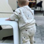 Brittany Daniel Instagram - Our little chubby cheeks is 11 months old. Also dying over this splatter paint sweatsuit by @ryleeandcru 😍