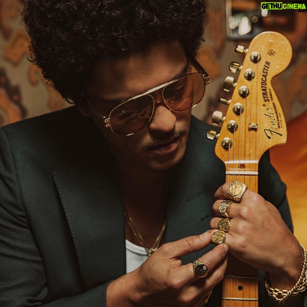 Bruno Mars Instagram - The @BrunoMars Stratocaster is a true treasure. Crafted from resonant ash, this limited edition guitar features sculpted American Ultra body contours for unmatched comfort and seamless access to high notes. The Mars Mocha Heirloom nitrocellulose lacquer finish not only gives it an aged charm, but also enhances resonance and tone. Head to the link in bio to learn more.