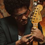 Bruno Mars Instagram – The @BrunoMars Stratocaster is a true treasure. Crafted from resonant ash, this limited edition guitar features sculpted American Ultra body contours for unmatched comfort and seamless access to high notes. The Mars Mocha Heirloom nitrocellulose lacquer finish not only gives it an aged charm, but also enhances resonance and tone. Head to the link in bio to learn more.