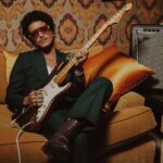 Bruno Mars Instagram – The @BrunoMars Stratocaster is a true treasure. Crafted from resonant ash, this limited edition guitar features sculpted American Ultra body contours for unmatched comfort and seamless access to high notes. The Mars Mocha Heirloom nitrocellulose lacquer finish not only gives it an aged charm, but also enhances resonance and tone. Head to the link in bio to learn more.