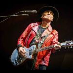 Chrissie Hynde Instagram - Nils Lofgren wearing the jacket I gave him (which I wore on my first album cover) and playing James Honeyman Scott’s Zermatis guitar at the recent Bruce Springsteen show in Hyde Park. Now, that’s what I call flying the flag. Nice one Nils! We love you! XCH
