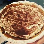 Chrissie Swan Instagram – At the behest of @s.j.talbot and many, many others… behold my Banoffee Pie recipe! 
What you’ll need:
1 packet McVitties Digestive biscuits.
100grams melted butter
1 tin condensed milk.
3 bananas
400ml cream, whipped with 2 tablespoons of caster sugar and slurp of vanilla extract. Makes it taste like vanilla icecream 🤤 
Dark chocolate (not much – just to grate on the top)

HERE’S WHAT TO DO:
Make the Dulce de leche. (You can buy a pre-made product called Caramel Top n Fill but I don’t like it anywhere near as much as the one I make below – reasonable shortcut though) 
Take label off a tin of condensed milk and place it in a saucepan full of water (leave the tin sealed). Make sure there’s a few centimetres of water above the top of the can (and I do about 5 at a time because this part takes the longest! They store in the fridge (sealed) forever and it means you can get a Banoffee on the table within minutes) 

Bring water to the boil then turn it down to a simmer, lid on, about 4-5 hours checking the water hasn’t evaporated. After that time I just leave it in the water to cool down (it takes hours). When it’s cool enough to open you have the most delicious caramel ever! 

BISCUIT BASE:
Blitz the biccies then stir in the melted butter. Push into a greased pie dish or square quiche tin – whatever you like – and bake for just 5 minutes on about 180. Whack into the fridge for a few hours until properly cold.

ASSEMBLE!
Spread your caramel onto the biccie base, arrange sliced bananas, top with whipped cream. Use a micro plane to grate some chocolate on top! 
Scoff.
❤️ 🍌 🥧