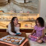 Chrissy Teigen Instagram - #NintendoPartner Spending time with Luna is THE best – first baking cookies together and now harvesting our island crops. We are LOVING these new Animal Crossing: New Horizons themed Nintendo Switch Lite systems. Luna loves it in coral, found exclusively at Target, and I prefer the turquoise, found exclusively at Walmart. Another bonus - they both come with the game! Check it out at Nintendo.com.