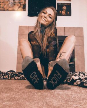 Daisy Coleman Instagram - What’s better than curling up next to the fireplace with a mug of hot coco while it’s snowing? 
The answer is curling up next to the fireplace with a mug of coco that I can smoke out of in my new socks from @inkedmag 😍 I think I might need five more of these because they’re just so perfect for the Holliday’s and stocking stuffers 🎅🏼🎄❄️❤️💚 #inkedholliday #inkedshop 
Use my code YOUNGCATTATTOOSINKEDHOLIDAY and link https://glnk.io/4y9/youngcattattoosinked to get a special discount 😍💚❤️