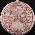 Davido Instagram - Davido’s bespoke pendant, dedicated to the success of his new album ‘Timeless’. A timeless ‘hourglass’ design, crafted with meticulous detail and hand selected diamonds. A moving hourglass, enclosed with diamond dust. A 350ct diamond pendant, weighing 1.5kg. Crafted with meticulous attention to detail. This exquisite pendant features hand-picked diamonds, constructed with a 1 carat pear diamond above the pendant. 4 - 0.5ct pear diamonds in the centre. A 30 pointer boarder for ‘30 Billion Gang’, as well as a 30 pointer boarder around the hourlgass. ‘30BG’ across the bespoke cuban chain. ‘30BG’ Baguette cut display. Designed in-house by our Local Kettle Brothers jewellery specialist team Cole, Emmanuel and Ethan. The "Timeless" pendant is a breathtaking masterpiece designed exclusively for Davido. A true embodiment of Davido’s unique style, the "Timeless" pendant is a symbol of inspiration, creativity, and enduring beauty that will adorn the wearer for generations to come.