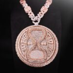 Davido Instagram - Davido’s bespoke pendant, dedicated to the success of his new album ‘Timeless’. A timeless ‘hourglass’ design, crafted with meticulous detail and hand selected diamonds. A moving hourglass, enclosed with diamond dust. A 350ct diamond pendant, weighing 1.5kg. Crafted with meticulous attention to detail. This exquisite pendant features hand-picked diamonds, constructed with a 1 carat pear diamond above the pendant. 4 - 0.5ct pear diamonds in the centre. A 30 pointer boarder for ‘30 Billion Gang’, as well as a 30 pointer boarder around the hourlgass. ‘30BG’ across the bespoke cuban chain. ‘30BG’ Baguette cut display. Designed in-house by our Local Kettle Brothers jewellery specialist team Cole, Emmanuel and Ethan. The "Timeless" pendant is a breathtaking masterpiece designed exclusively for Davido. A true embodiment of Davido’s unique style, the "Timeless" pendant is a symbol of inspiration, creativity, and enduring beauty that will adorn the wearer for generations to come.