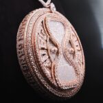 Davido Instagram - Davido’s bespoke pendant, dedicated to the success of his new album ‘Timeless’. A timeless ‘hourglass’ design, crafted with meticulous detail and hand selected diamonds. A moving hourglass, enclosed with diamond dust. A 350ct diamond pendant, weighing 1.5kg. Crafted with meticulous attention to detail. This exquisite pendant features hand-picked diamonds, constructed with a 1 carat pear diamond above the pendant. 4 - 0.5ct pear diamonds in the centre. A 30 pointer boarder for ‘30 Billion Gang’, as well as a 30 pointer boarder around the hourlgass. ‘30BG’ across the bespoke cuban chain. ‘30BG’ Baguette cut display. Designed in-house by our Local Kettle Brothers jewellery specialist team Cole, Emmanuel and Ethan. The "Timeless" pendant is a breathtaking masterpiece designed exclusively for Davido. A true embodiment of Davido’s unique style, the "Timeless" pendant is a symbol of inspiration, creativity, and enduring beauty that will adorn the wearer for generations to come.