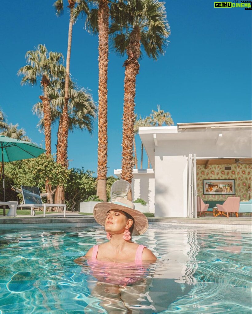 Dawn McCoy Instagram - Sunset and sunrise swims every single day are simply my kind of heaven. This house, @splashofink_ps - pictured here - is the kind of house that makes you fall in love with Palm Springs.🌴 With color galore - and the consummate indoor-outdoor living space - we spent the bulk of our time in the pool or hot tub. Looking at my calendar the next few months, there’s a lot of Palm Springs penciled in there - for work, for Modernism Week and for some other big stuff. And thinking about all that’s up ahead could be downright daunting, but when I think of those soaks and swims with my son? I just can’t wait to get back.🩵 House hosted by @splashofink_ps managed by @wanderluxe_vacation_rentals Branded & designed by @johnpatrickpalmsprings 📷: @andrewcabral_photography Swimsuit: @showmeyourmumu Hat: @trinaturk - styled by @denise_in_socal Palm Springs, California