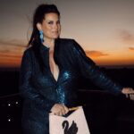 Dawn McCoy Instagram - An @ElieTahari Friendsgiving at sunset hosted by my beautiful friend @elizabethkeene was just what my already full heart needed to kick off the holiday season. Filled with fierce female friends I love - and some friends I haven’t seen in WAY too long - it was just a night filled with love, encouragement and truth talk. I can’t wait to share more tomorrow. But for now… Thank you, @elietahari for dressing me and making my Lynda Carter-meets-Joan Collins-meets-David Bowie sapphire-sequined dreams come true with this beautiful ensemble.💙🩵 Thank you, @christophermilesmakeup for bringing this beauty look to life with @lancomeofficial & @nyxcosmetics. And, thank you @kellygolightly x @bethladdcollections for this stunning swan clutch from your collaboration capsule.🦢🦢🦢 I was so honored to debut it in Los Angeles and can’t wait to don it tomorrow again for the Black & White Ball. 🖤🤍🦢 #ElieGirl #ElieTahariCollection #FallInLoveWithLuxury #FallingForLuxury Wearing @elietahari Swan beaded clutch: @kellygolightly x @bethladdcollections Makeup: @christophermilesmakeup Hair: Adriana Shoes: @seychellesshoes at @trinaturk @denise_in_socal Event details: 📷: @irik Catering: @eats_by_connor Wine: @boeschenvineyards 🍷 Beauty details: @nyxcosmetics butter gloss in crème brulee @lancomeofficial eyeshadow @makeupbymario blush @chanelofficial foundation @charlottetilbury bronzer & eyeliner Manhattan Beach, California
