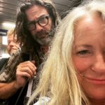 Deana Carter Instagram – My sweet lil’G in her “missing us yoga pose” & another travel day. Look at these characters behind me! 👀 Pardon my “rat’s nest” o’hair!! Looking forward to #wildwoodnj show tomorrow! 🙌🏻💖 Philadelphia International Airport