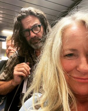 Deana Carter Instagram - My sweet lil’G in her “missing us yoga pose” & another travel day. Look at these characters behind me! 👀 Pardon my “rat’s nest” o’hair!! Looking forward to #wildwoodnj show tomorrow! 🙌🏻💖