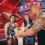 Dwayne Johnson Instagram – She wears black.
I love black. 
She’s a bad ass. 
And I got famous for wearing a fanny pack. 
We had fun f*cking around backstage 😈🥃

Love, appreciate and respect you champ @rhearipley_wwe – thanks for trusting me with your title, keep kickin’ ass and raising the bar 🖤💪🏾

Big shout to @cathykelley for being a total pro and having fun 🎤 👊🏾

#peopleschamp ✊🏾

📸 @flanneryunderwood @wwe