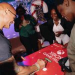 Dwayne Johnson Instagram – Had to go with the JUMANJI overture for this one, since he wants to be an actor and he’s already taller than @kevinhart4real☝🏾🎬🎥 

This is Mcharris Hodonou from @makeawishamerica! 

He’s 17 and my guy here is awesome! 

Mcharris’ wish was to meet me. 

And this kid RADIATES POSITIVE ENERGY!! 

We had a blast hanging out, laughing, talking about Hollywood and his goal to be a Hollywood action star one day 🎬 🎥 

I told him he’s gotta keep putting in the relentless hard work – years and years of it – and one door begins to open the next door, and the next, and the next. 

Keep radiating that joy! 

Lots of noise and negative energy out there, but there’s also lots of positive, uplifting stuff too – and Mcharris is one of them! 

#MakeAWishDay
#21Kids
#BestDayEver