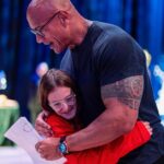Dwayne Johnson Instagram – I turn into a big emotional dinosaur 🦖🥹 when I meet these little girls who look at me like this – because it reminds me of my three daughters that I’ve been blessed with. 

This is Maya Walter from @makeawishamerica. 

She’s 11 and she’s awesome! 

This heart stealer was such a joy to spend time with. So cool, calm, poised and beautiful energy and demeanor. 

BUT, don’t get it twisted, she’s also a bad ass and a real fighter too! Don’t let that smile fool ya 🥰😉

We hung out. 
I signed her cast (crazy story about her break 👀) 
She gave me awesome bracelets – representing lyrics from my rap song “FACE OFF” 

💥It’s about drive, it’s about power 💥 

Lots of toxicity out there in the world, but if you look past that – there’s much more positivity and hope – and Maya is a shining example of that. 

#MakeAWishDay
#21Kids 
#BestDayEver 
#TeamGirlDad
