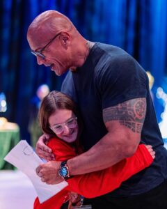 Dwayne Johnson Instagram - I turn into a big emotional dinosaur 🦖🥹 when I meet these little girls who look at me like this - because it reminds me of my three daughters that I’ve been blessed with. This is Maya Walter from @makeawishamerica. She’s 11 and she’s awesome! This heart stealer was such a joy to spend time with. So cool, calm, poised and beautiful energy and demeanor. BUT, don’t get it twisted, she’s also a bad ass and a real fighter too! Don’t let that smile fool ya 🥰😉 We hung out. I signed her cast (crazy story about her break 👀) She gave me awesome bracelets - representing lyrics from my rap song “FACE OFF” 💥It’s about drive, it’s about power 💥 Lots of toxicity out there in the world, but if you look past that - there’s much more positivity and hope - and Maya is a shining example of that. #MakeAWishDay #21Kids #BestDayEver #TeamGirlDad