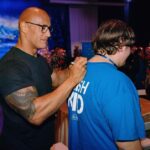 Dwayne Johnson Instagram – Droppin that old school Rock theme music for my boy Jayden Harden from @makeawishamerica! 

Jayden is 15 and he’s awesome!! 

Jayden’s wish was to meet, “the people’s champ”. 

He is a HUUUUUGE ROCK & pro wrestling fan and we had a BLAST chopping up his favorite wrestlers and matches!! 

I LOVE pro wrestling so my time with Jayden was super dope! 💪🏾🩵

I told him a little secret 🤫 that may or may not involve some dude returning to WWE to lay the SmackDown on all their candy asses 😉👋🏾

There’s a lot of negative and toxic noise out there in the world – but there’s a lot of positive, good things too, and Jayden is one of them. 

#MakeAWishDay 
#21Kids 
#BestDayEver