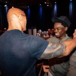 Dwayne Johnson Instagram – Had to go with the JUMANJI overture for this one, since he wants to be an actor and he’s already taller than @kevinhart4real☝🏾🎬🎥 

This is Mcharris Hodonou from @makeawishamerica! 

He’s 17 and my guy here is awesome! 

Mcharris’ wish was to meet me. 

And this kid RADIATES POSITIVE ENERGY!! 

We had a blast hanging out, laughing, talking about Hollywood and his goal to be a Hollywood action star one day 🎬 🎥 

I told him he’s gotta keep putting in the relentless hard work – years and years of it – and one door begins to open the next door, and the next, and the next. 

Keep radiating that joy! 

Lots of noise and negative energy out there, but there’s also lots of positive, uplifting stuff too – and Mcharris is one of them! 

#MakeAWishDay
#21Kids
#BestDayEver