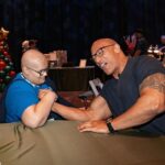 Dwayne Johnson Instagram – This is Adelaide Bomberger from @makeawishamerica. 

She’s 17 and awesome. 

Adelaide’s wish was to meet me, beat me at arm wrestling, and do our VERY special bald head touch handshake – so I can have the honor of joining her “bad ass team bald club”. 

She succeeded at all three 3️⃣ ☑️ 🥰 

Amazing kid. 
I’m lucky to meet her. 

Stay strong Adelaide — you inspire everyone around you, including me. 

A lot of positive and good stuff still happening around the world, and Adelaide is one of them. 

#MakeAWishDay
#21Kids 
#BestDayEver