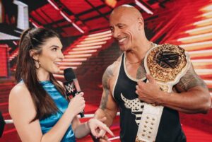 Dwayne Johnson Instagram - She wears black.
I love black. 
She’s a bad ass. 
And I got famous for wearing a fanny pack. 
We had fun f*cking around backstage 😈🥃

Love, appreciate and respect you champ @rhearipley_wwe - thanks for trusting me with your title, keep kickin’ ass and raising the bar 🖤💪🏾

Big shout to @cathykelley for being a total pro and having fun 🎤 👊🏾

#peopleschamp ✊🏾

📸 @flanneryunderwood @wwe