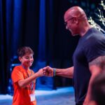 Dwayne Johnson Instagram – Already more muscles than me – just another day in the life of Peyton Frederick from @makeawishamerica. 😉💪🏾

He’s 10 and he’s awesome! 

Peyton’s wish was to meet me. 

And man this kid lights up the room with his awesome personality!! 

Loves playing sports and already establishing those building blocks of discipline of the hardest workers in the room. 

He was proud to let me know he had gotten his morning workout in before we met 😄👏🏾💪🏾

We had a lot of laughs together and I was very impressed with this kid. He could go on to become a pro athlete one day and I just hope he gives me free tickets 🎟️ 🤣 

A lot of negative noise out there in the world, but there’s also a lot of amazing positive things too, and Peyton is one of them! 

#MakeAWishDay
#21Kids 
#BestDayEver