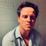 Emilia Clarke Instagram - The beautiful, breathtaking talent that is Andrew Scott reads for us ‘Everything is Going to be All Right’ by Derek Mahon. Andrew has asked to dedicate this to Men Against Cancer Ireland https://macprostatecancersupport.ie/men-against-cancer/ Andrew we salute you! 🕺 It comes under the prescription for need for reassurance. Here’s how it reads as written in the book @thepoetrypharmacy @thepoetryremedy There are moments in life when the banal suddenly, and quite without warning, becomes the transcendent. Perhaps a shaft of afternoon light paints a familiar view an unfamiliar gold; perhaps dust in a sunbeam or the dance of sparks above a fire transport you, for a long instant, to somewhere else altogether. The almost magical-seeming reflections of ripples on a ceiling are transfixing in just the same way. In moments like these- awe-struck moments when the ferocious beauty of the everyday catches us unawares- we are often moved to a reassessment. One flash of sunlight can be all it takes to give us the sense of possibility that can change everything. As a great sufferer from depression myself, I find a small moment like this, a sudden splash of serenity and beauty, can provide the impetus needed to run my mood around. Not completely, perhaps, and not permanently- but sometimes a small push is all any of us is waiting for. Derek Mahon’s poem ‘Everything is Going to be All Right’ describes wonderfully the feeling of that little push and reassessment. And there’s something hugely powerful, too, about its final line. When my children are suffering and I hold them in my arms, it seems to be the most natural mantra in the world: Everything will be all right. There’s a comfort to those words, whether or not they’ll prove to be true. OF course, some wounds don’t heal, and some wrongs go un-righted. But in the grander sense, in the everything sense, things to tend to be all right. Too often, our pain is either in our heads or magnified beyond all proportion. If we can learn to manage it, if we can find that oasis of calm in the reflection of the waves, then we might find that out problems are not as all-consuming as we imagined. Thank you thank you Andrew!