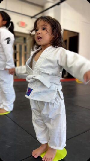 Frank Camacho Instagram - Stepping onto the mat with the biggest little smile, my 2-year-old girl began her first #Purebred Tiny Smashers Jiujitsu class today and my heart is doing somersaults! 🌟🥋✨ It’s more than just cute gi’s and playful tumbles; it’s about shaping her young mind with respect, teamwork, physical health, and discipline. 💪🧠 This is where she’ll learn to fall and rise, and embrace the joy of the journey. If you’re ready for your little ones to start a path filled with fun, fitness, and lifelong lessons, send us a message! 📩👶🤼‍♂️ #ProudDad #FirstGi #JiujitsuKids #sharejiujitsu #purebredjiujitsu