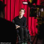 George Robinson Instagram - I am much much happier to be involved in this than I look! ——————————————— #repost from @backuptrust We’re pleased to announce that we’re making a film starring @Georgerossrobinson! The Sex Education star's story will be told in the first of a series of short films that challenge perceptions of what is possible with a disability, and educate the viewer about life with a spinal cord injury. George speaks with us about his injury, how it transformed his life, and how Back Up was there to support him and his loved ones. Keep an eye out on our account for regular updates - if you enjoyed Rising Phoenix on Netflix this is not something you'd want to miss! Special thanks to @Visaramedia for producing this project, and @Directdigitalhq for sponsoring film equipment. 📸 @Clairemorrisphotography