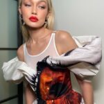 Gigi Hadid Instagram - Celebrated NIF last night in McQueen & some @maybelline favorites — the NEW (major) Falsies Surreal Mascara, Fit Me Foundation, and an oldie but a goodie- Color Blur in “Orange Ya Glad” ❤️‍🔥 (check out @patrickta’s tiktok for a silly GRW[Us]) x New York, New York