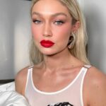 Gigi Hadid Instagram - Celebrated NIF last night in McQueen & some @maybelline favorites — the NEW (major) Falsies Surreal Mascara, Fit Me Foundation, and an oldie but a goodie- Color Blur in “Orange Ya Glad” ❤️‍🔥 (check out @patrickta’s tiktok for a silly GRW[Us]) x New York, New York